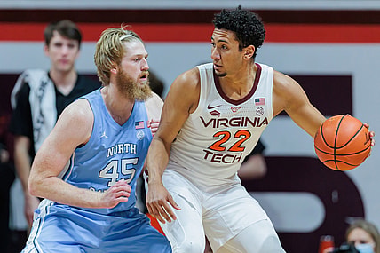 Feb 19, 2022; Blacksburg, Virginia, USA; Virginia Tech Hokies forward Keve Aluma (22) is defended by North Carolina Tar Heels forward Brady Malek (45) during the first half at Cassell Coliseum. Mandatory Credit: Ryan Hunt-USA TODAY Sports