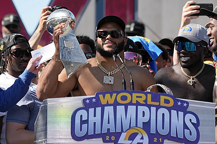 Feb 16, 2022; Los Angeles, CA, USA; Los Angeles Rams defensive end Aaron Donald holds the Vince Lombardi trophy during the Super Bowl LVI championship rally at the Los Angeles Memorial Coliseum. Mandatory Credit: Kirby Lee-USA TODAY Sports