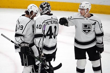 Feb 23, 2022; Glendale, Arizona, USA; Los Angeles Kings left wing Alex Iafallo (19) and Los Angeles Kings goaltender Cal Petersen (40) and Los Angeles Kings right wing Dustin Brown (23) celebrate after the third period against the Arizona Coyotes at Gila River Arena. Mandatory Credit: Joe Camporeale-USA TODAY Sports