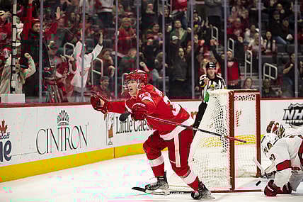 Mar 1, 2022; Detroit, Michigan, USA; Detroit Red Wings left wing Lucas Raymond (23) scores the game winning goal during overtime against Carolina Hurricanes goaltender Antti Raanta (32) at Little Caesars Arena. Mandatory Credit: Raj Mehta-USA TODAY Sports