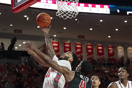 Mar 3, 2022; Houston, Texas, USA;  Houston Cougars guard Kyler Edwards (11) shoots against Temple Owls guard Hysier Miller (4) in the first half at Fertitta Center. Mandatory Credit: Thomas Shea-USA TODAY Sports