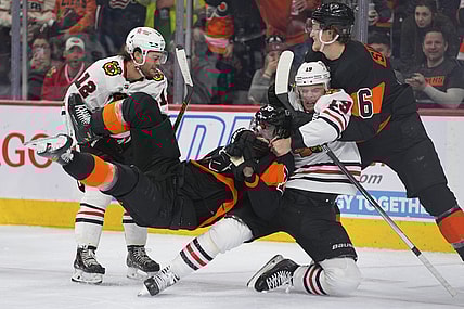 Mar 5, 2022; Philadelphia, Pennsylvania, USA; Chicago Blackhawks center Jonathan Toews (19) pulls Philadelphia Flyers defenseman Rasmus Ristolainen (70) to the ice in the second period at the Wells Fargo Center. Mandatory Credit: Mitchell Leff-USA TODAY Sports