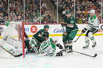 Mar 6, 2022; Saint Paul, Minnesota, USA; Minnesota Wild center Frederick Gaudreau (89), goaltender Kaapo Kahkonen (34) and Dallas Stars center Tyler Seguin (91) watch the puck go by Minnesota Wild defenseman Dmitry Kulikov (29) on its way to the back of the net to tie the game in the first period at Xcel Energy Center. Mandatory Credit: Matt Blewett-USA TODAY Sports