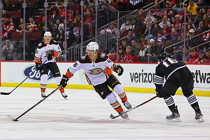 Mar 12, 2022; Newark, New Jersey, USA; Anaheim Ducks center Trevor Zegras (46) skates with the puck while being defended by New Jersey Devils left wing Jimmy Vesey (16) during the first period at Prudential Center. Mandatory Credit: Ed Mulholland-USA TODAY Sports