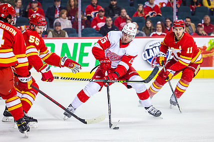 Mar 12, 2022; Calgary, Alberta, CAN; Detroit Red Wings left wing Jakub Vrana (15) controls the puck against the Calgary Flames during the first period at Scotiabank Saddledome. Mandatory Credit: Sergei Belski-USA TODAY Sports