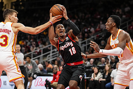 Mar 14, 2022; Atlanta, Georgia, USA; Portland Trail Blazers guard Kris Dunn (18) drives to the basket against Atlanta Hawks guard Bogdan Bogdanovic (13) and forward Onyeka Okongwu (17) during the first quarter at State Farm Arena. Mandatory Credit: Dale Zanine-USA TODAY Sports