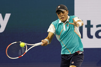 Mar 25, 2022; Miami Gardens, FL, USA; Brandon Nakashima (USA) hits a forehand against Frances Tiafoe (USA) (not pictured) in a second round men's singles match in the Miami Open at Hard Rock Stadium. Mandatory Credit: Geoff Burke-USA TODAY Sports