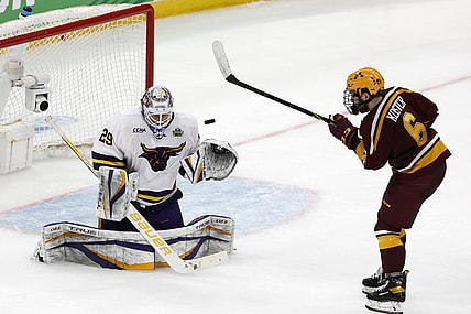 Apr 7, 2022; Boston, MA, USA; Minnesota State goaltender Dryden McKay (29) makes a save as Minnesota defenseman Mike Koster (6) looks for the rebound during the third period of the 2022 Frozen Four college ice hockey national semifinals at TD Garden. Mandatory Credit: Winslow Townson-USA TODAY Sports