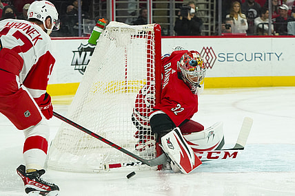 Apr 14, 2022; Raleigh, North Carolina, USA;  Carolina Hurricanes goaltender Antti Raanta (32) watches the puck against Detroit Red Wings defenseman Filip Hronek (17) during the first periodat PNC Arena. Mandatory Credit: James Guillory-USA TODAY Sports