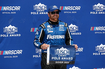 Apr 30, 2022; Dover, Delaware, USA; NASCAR Cup Series driver Chris Buescher stands with the Busch Light Pole Award after winning the pole during qualifying for the DuraMAX Drydene 400 at Dover Motor Speedway. Mandatory Credit: Matthew OHaren-USA TODAY Sports
