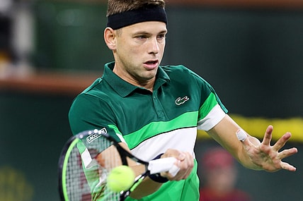 Filip Krajinovic of Serbia returns a shot to Daniil Medvedev of Russia on Stadium One during the BNP Paribas Open in Indian Wells, Calif., on October 11, 2021.

Daniil Medvedev Vs Filip Krajinovic Bnp Paribas2104
