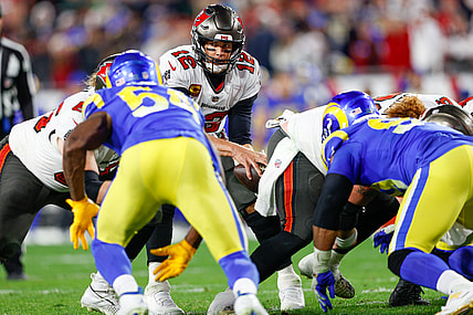 Jan 23, 2022; Tampa, Florida, USA; Tampa Bay Buccaneers quarterback Tom Brady (12) takes the snap before running back Leonard Fournette (7) (not pictured) scored a touchdown in the fourth quarter against the Los Angeles Rams during the NFC Divisional playoff football game at Raymond James Stadium. Mandatory Credit: Nathan Ray Seebeck-USA TODAY Sports
