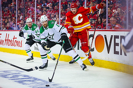 May 3, 2022; Calgary, Alberta, CAN; Dallas Stars defenseman Jani Hakanpaa (2) and Calgary Flames right wing Brett Ritchie (24) battle for the puck during the third period in game one of the first round of the 2022 Stanley Cup Playoffs at Scotiabank Saddledome. Mandatory Credit: Sergei Belski-USA TODAY Sports