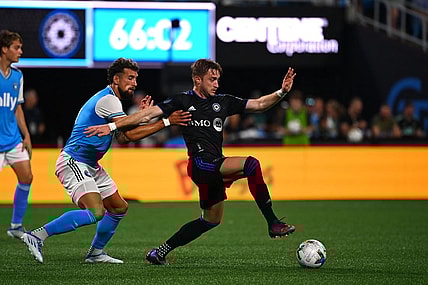 May 14, 2022; Charlotte, North Carolina, USA;  CF Montreal midfielder Djordje Mihailovic (8) with the ball as Charlotte FC defender Guzman Corujo (4) defends in the second half at Bank of America Stadium. Mandatory Credit: Bob Donnan-USA TODAY Sports