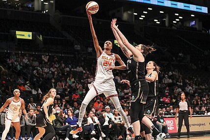 May 17, 2022; Brooklyn, New York, USA;  Connecticut Sun forward DeWanna Bonner (24) moves past New York Liberty center Stefanie Dolson (31) in the third quarter at Barclays Center. Mandatory Credit: Wendell Cruz-USA TODAY Sports