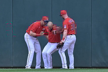 May 29, 2022; Minneapolis, Minnesota, USA; Minnesota Twins left fielder Trevor Larnach (13) and right fielder Kyle Garlick (30) help center fielder Royce Lewis (23) off the ground after Lewis made a catch against the Kansas City Royals during the third inning at Target Field. Lewis would leave the game the following inning. Mandatory Credit: Jeffrey Becker-USA TODAY Sports