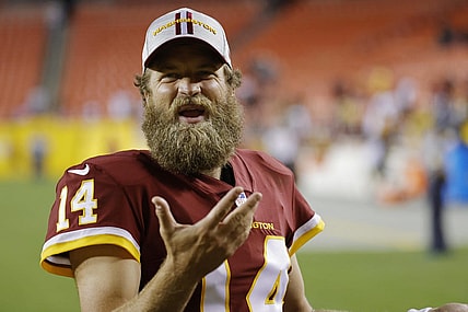 Aug 20, 2021; Landover, Maryland, USA; Washington Football Team quarterback Ryan Fitzpatrick (14) talks to fans while leaving the field after the Washington Football Team's game against the Cincinnati Bengals at FedExField. Mandatory Credit: Geoff Burke-USA TODAY Sports