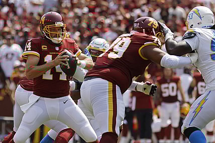 Sep 12, 2021; Landover, Maryland, USA; Washington Football Team quarterback Ryan Fitzpatrick (14) prepares to pass the ball against the Los Angeles Chargers at FedExField. Mandatory Credit: Geoff Burke-USA TODAY Sports