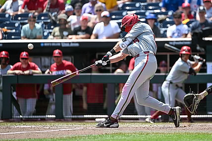 Jun 18, 2022; Omaha, NE, USA;  Arkansas Razorbacks right fielder Chris Lanzilli (18) launches a three-run home run in the fifth inning against the Stanford Cardinal at Charles Schwab Field. Mandatory Credit: Steven Branscombe-USA TODAY Sports