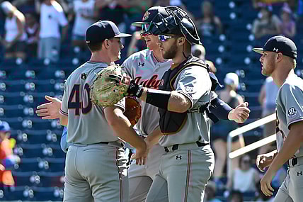 Jun 20, 2022; Omaha, NE, USA;  Auburn Tigers pitcher Blake Burkhalter (40) and catcher Nate LaRue (28) meet after the win against the Stanford Cardinal at Charles Schwab Field. Mandatory Credit: Steven Branscombe-USA TODAY Sports