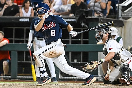 Jun 20, 2022; Omaha, NE, USA;  Ole Miss Rebels center fielder Justin Bench (8) drives in a run against the Arkansas Razorbacks in the eighth inning at Charles Schwab Field. Mandatory Credit: Steven Branscombe-USA TODAY Sports