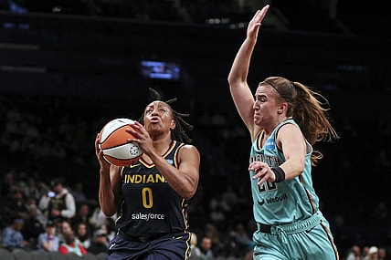 Jun 1, 2022; Brooklyn, New York, USA; Indiana Fever guard Kelsey Mitchell (0) drives past New York Liberty guard Sabrina Ionescu (20) in the first quarter at Barclays Center. Mandatory Credit: Wendell Cruz-USA TODAY Sports