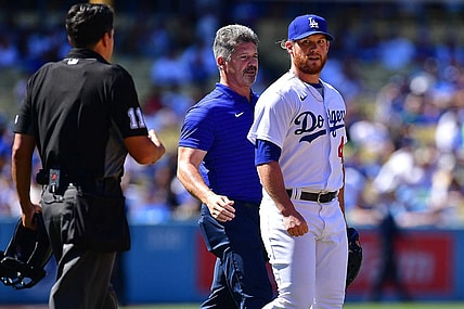 Jul 3, 2022; Los Angeles, California, USA; Los Angeles Dodgers relief pitcher Craig Kimbrel (46) with trainer Nate Lucero after taking a comeback hit by San Diego Padres second baseman Jake Cronenworth (9) during the ninth inning at Dodger Stadium. Mandatory Credit: Gary A. Vasquez-USA TODAY Sports
