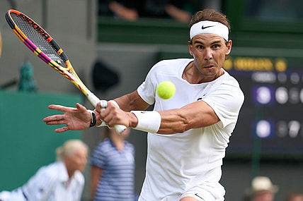 Jul 6, 2022; London, England, United Kingdom; Rafael Nadal (ESP) returns a shot during his quarter finals men   s singles match against Taylor Fritz (USA) on Centre court at All England Lawn Tennis and Croquet Club. Mandatory Credit: Peter van den Berg-USA TODAY Sports