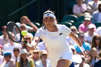 Jul 7, 2022; London, England, United Kingdom;  Ons Jabeur (TUN) returns a shot during  her semi finals women   s singles match against Tatjana Maria (GER) on Centre court at All England Lawn Tennis and Croquet Club. Mandatory Credit: Peter van den Berg-USA TODAY Sports