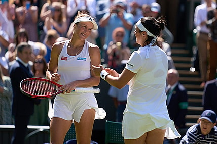 Jul 7, 2022; London, England, United Kingdom;  Ons Jabeur (TUN), pictured right, celebrates at the net after her semi finals women s singles match against Tatjana Maria (GER) who is a close friend on Centre court at All England Lawn Tennis and Croquet Club. Mandatory Credit: Peter van den Berg-USA TODAY Sports