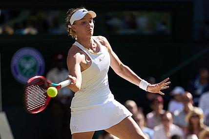 Jul 7, 2022; London, England, United Kingdom;  Elena Rybakina (KAZ) returns a shot during her semi-finals women   s singles match against Simona Halep (ROU) on Centre court at All England Lawn Tennis and Croquet Club. Mandatory Credit: Peter van den Berg-USA TODAY Sports