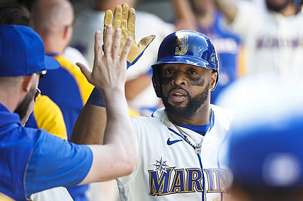 Jul 10, 2022; Seattle, Washington, USA; Seattle Mariners first baseman Carlos Santana (41) high-fives teammates in the dugout following a two-run home run against the Toronto Blue Jays during the eighth inning at T-Mobile Park. Mandatory Credit: Joe Nicholson-USA TODAY Sports