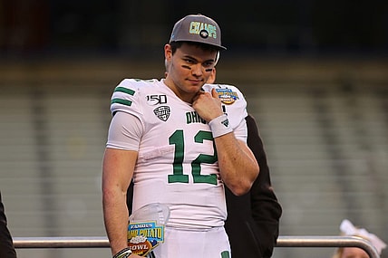 Jan 3, 2020; Boise, Idaho, USA; Ohio Bobcats quarterback Nathan Rourke (12) receives the Famous Idaho Potato Bowl most valuable player trophy after defeating the Nevada Wolf Pack at Albertsons Stadium. Ohio won 30-21. Mandatory Credit: Brian Losness-USA TODAY Sports