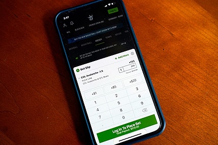 Photo illustration of the Draft Kings app on an iPhone.

News Online Sports Betting Project