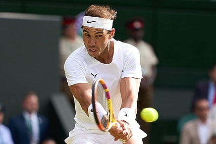 Jul 6, 2022; London, England, United Kingdom; Rafael Nadal (ESP) returns a shot during his quarter finals men   s singles match against Taylor Fritz (USA) on Centre court at All England Lawn Tennis and Croquet Club. Mandatory Credit: Peter van den Berg-USA TODAY Sports