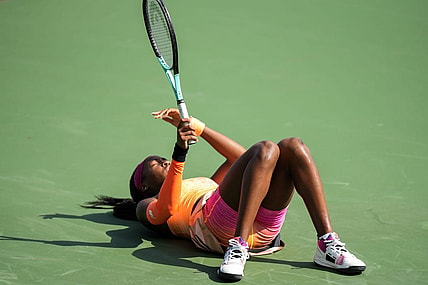 Coco Gauff falls after rushing to get the ball during her match against Marle Bouzkova on the Grand Stand court at the 2022 Western & Southern Open on Tuesday August 16. Gauff forfeit during the second set after receiving an injury.