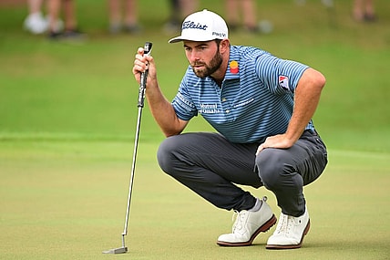 Aug 25, 2022; Atlanta, Georgia, USA; Cameron Young lines a putt on the 1st green during the first round of the TOUR Championship golf tournament. Mandatory Credit: Adam Hagy-USA TODAY Sports