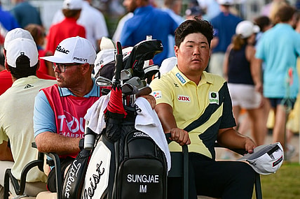 Aug 27, 2022; Atlanta, Georgia, USA; Sungjae Im and his caddie William Spencer ride back to the club house in a golf cart during a weather delay during the third round of the TOUR Championship golf tournament. Mandatory Credit: Adam Hagy-USA TODAY Sports