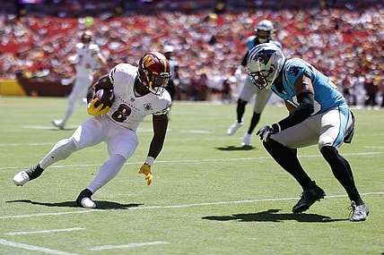 Aug 13, 2022; Landover, Maryland, USA; Washington Commanders running back Brian Robinson (8) runs with the ball as Carolina Panthers cornerback Chris Westry (39) defends during the second quarter at FedExField. Mandatory Credit: Geoff Burke-USA TODAY Sports