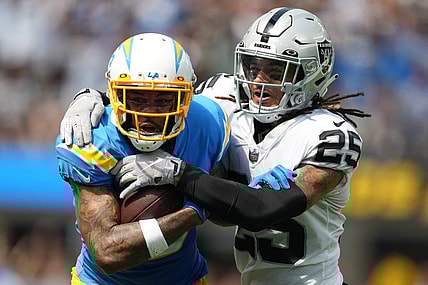 Sep 11, 2022; Inglewood, California, USA; Los Angeles Chargers wide receiver Keenan Allen (13) tries to break free from the grasp of Las Vegas Raiders safety Tre'von Moehrig (25) in the first half at SoFi Stadium. Mandatory Credit: Kirby Lee-USA TODAY Sports