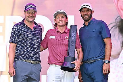 Sep 18, 2022; Chicago, Illinois, USA; Cameron Smith holds the winning trophy while posing with runner up Peter Uihlein, far left, and third place finisher Dustin Johnson after the final round of the Invitational Chicago LIV Golf tournament at Rich Harvest Farms. Mandatory Credit: Jamie Sabau-USA TODAY Sports