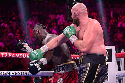 Oct 9, 2021; Las Vegas, Nevada, USA; Deontay Wilder (red/black trunks) is knocked out by Tyson Fury (black/gold trunks) during their WBC/Lineal heavyweight championship boxing match at T-Mobile Arena. Mandatory Credit: Joe Camporeale-USA TODAY Sports