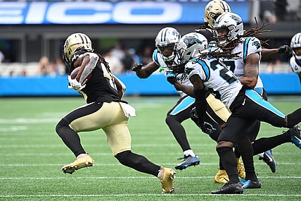 Sep 25, 2022; Charlotte, North Carolina, USA; New Orleans Saints running back Alvin Kamara (41) with the ball as Carolina Panthers cornerback Jaycee Horn (8) and linebacker Shaq Thompson (7) and safety Jeremy Chinn (21) defend in the fourth quarter at Bank of America Stadium. Mandatory Credit: Bob Donnan-USA TODAY Sports