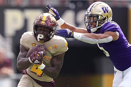 Oct 8, 2022; Tempe, Arizona, USA; Arizona State Sun Devils running back Daniyel Ngata (4) runs against Washington Huskies safety Alex Cook (5) during the first half at Sun Devil Stadium. Mandatory Credit: Joe Camporeale-USA TODAY Sports