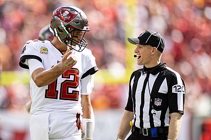 Oct 9, 2022; Tampa, Florida, USA; Tampa Bay Buccaneers quarterback Tom Brady (12) discusses a call with side judge Jonah Monroe (120) during the second half against the Atlanta Falcons at Raymond James Stadium. Mandatory Credit: Matt Pendleton-USA TODAY Sports