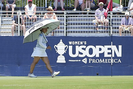 Jun 2, 2022; Southern Pines, North Carolina, USA; Ai Suzuki protects herself from the heat with an umbrella during the first round of the U.S. Women's Open. Mandatory Credit: David Yeazell-USA TODAY Sports