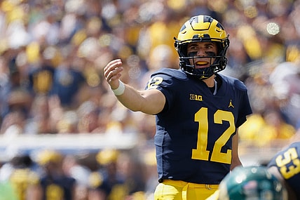 Sep 3, 2022; Ann Arbor, Michigan, USA;  Michigan Wolverines quarterback Cade McNamara (12) gets set to run a play against the Colorado State Rams at Michigan Stadium. Mandatory Credit: Rick Osentoski-USA TODAY Sports