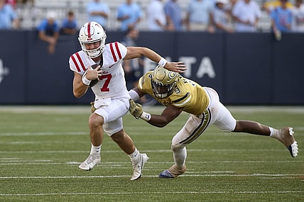 Sep 17, 2022; Atlanta, Georgia, USA; Mississippi Rebels quarterback Luke Altmyer (7) runs past Georgia Tech Yellow Jackets defensive lineman Kyle Kennard (9) in the second half at Bobby Dodd Stadium. Mandatory Credit: Brett Davis-USA TODAY Sports