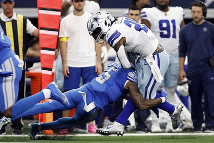 Oct 23, 2022; Arlington, Texas, USA; Dallas Cowboys running back Ezekiel Elliott (21) is tackled by Detroit Lions safety DeShon Elliott (5) in the second quarter at AT&T Stadium. Mandatory Credit: Tim Heitman-USA TODAY Sports