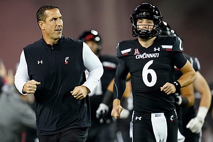 Cincinnati Bearcats head coach Luke Fickell and quarterback Ben Bryant (6) take the field for the first quarter of the NCAA American Athletic Conference game between the Cincinnati Bearcats and the East Carolina Pirates at Nippert Stadium in Cincinnati on Friday, Nov. 11, 2022.

East Carolina Pirates At Cincinnati Bearcats Football